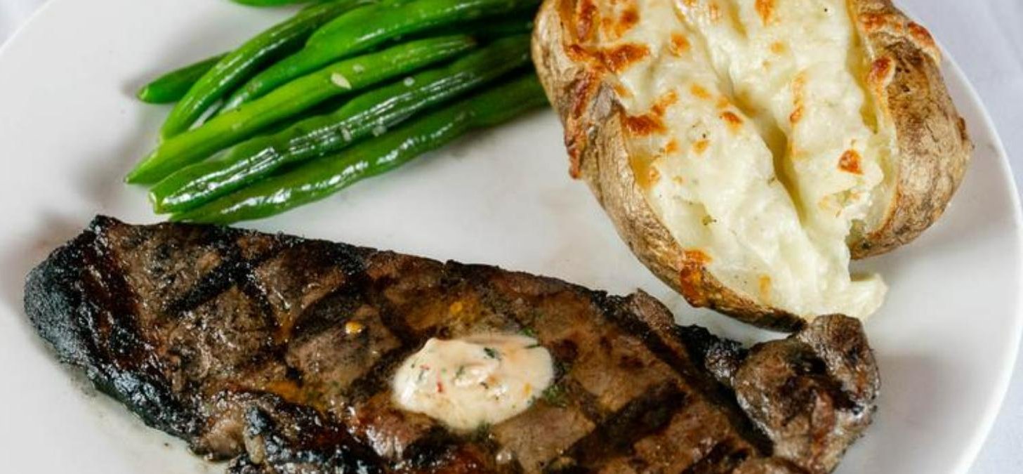 Grilled steak with twice-baked potato and green beans at Buddy's